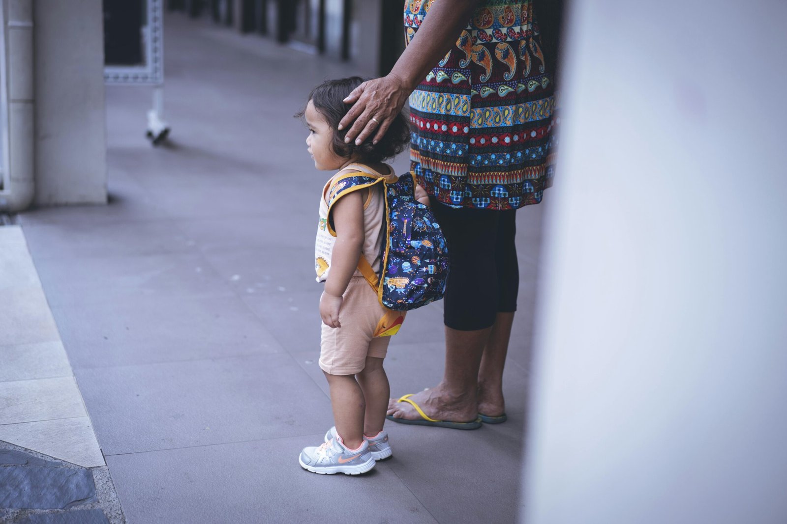 Parent gently comforting a child before nursery drop-off to manage anxiety
